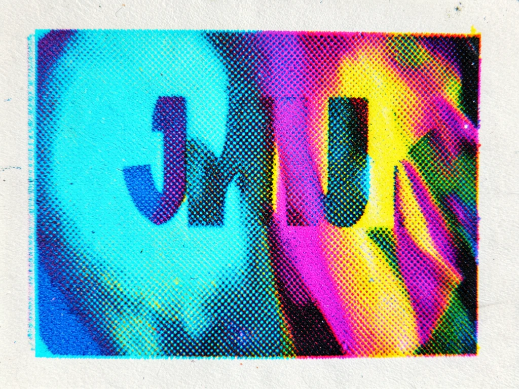 Screenprinted text in process color with slight misregistration, colored halos a