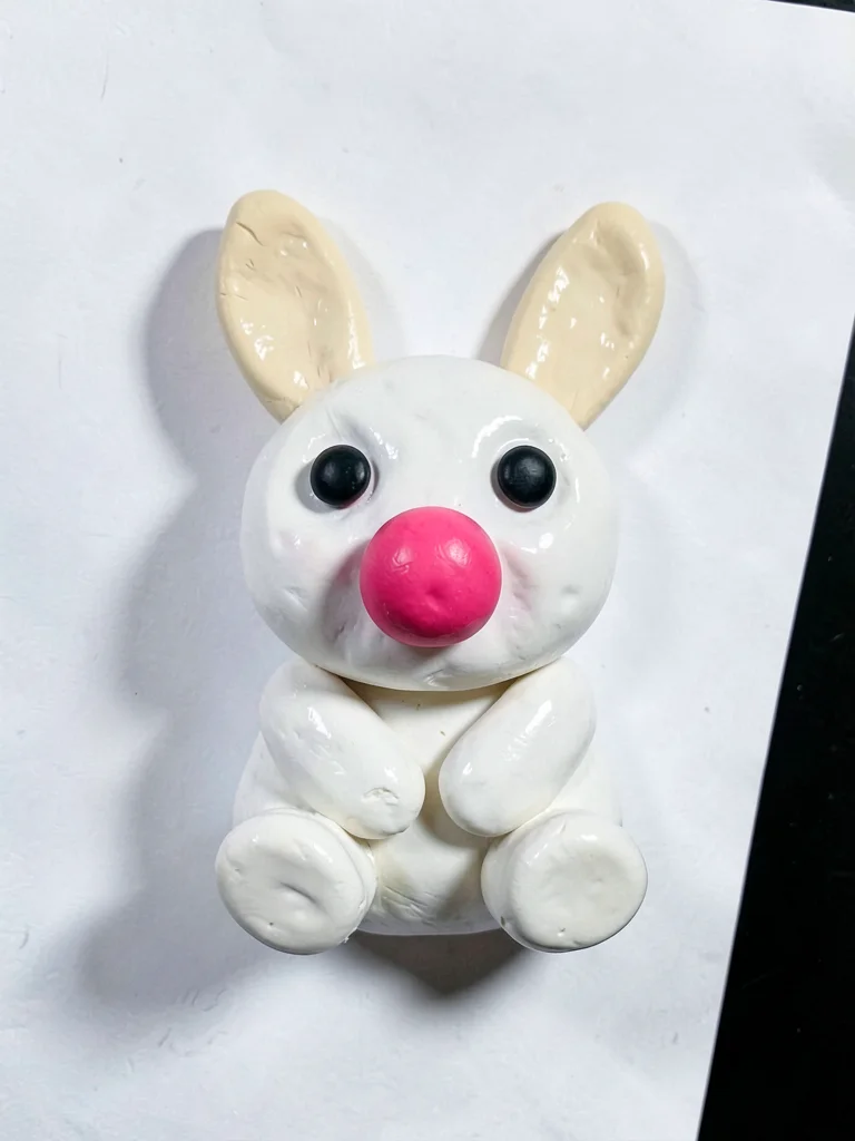Soft chunky clay bunny in primary white with stubby cream-toned ears and oversiz