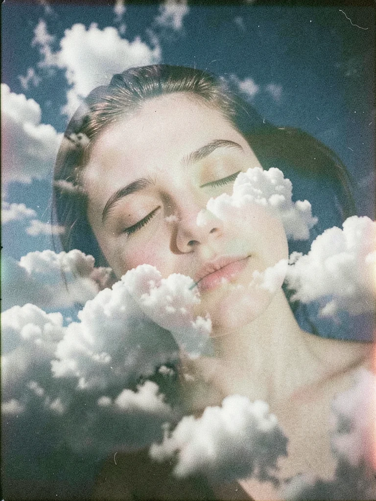 A sleeping face double-exposed with clouds, the dreamer's expression peaceful am
