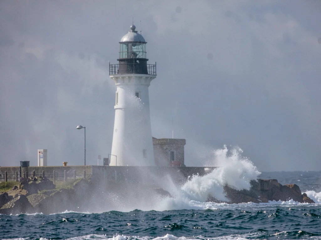 Lighthouse partially obscured by spray
