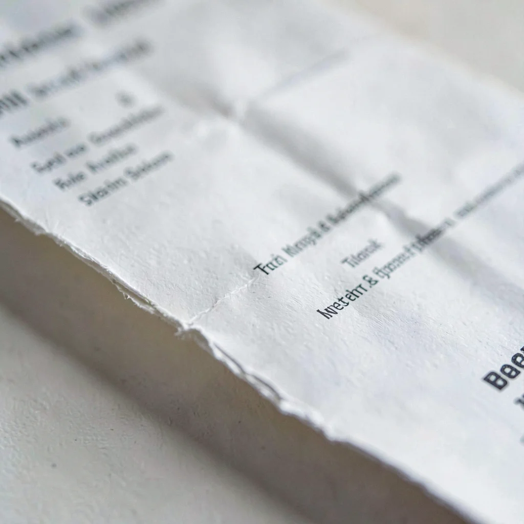 Macro of a folded resume page with rounded creases, soft light catching the deck