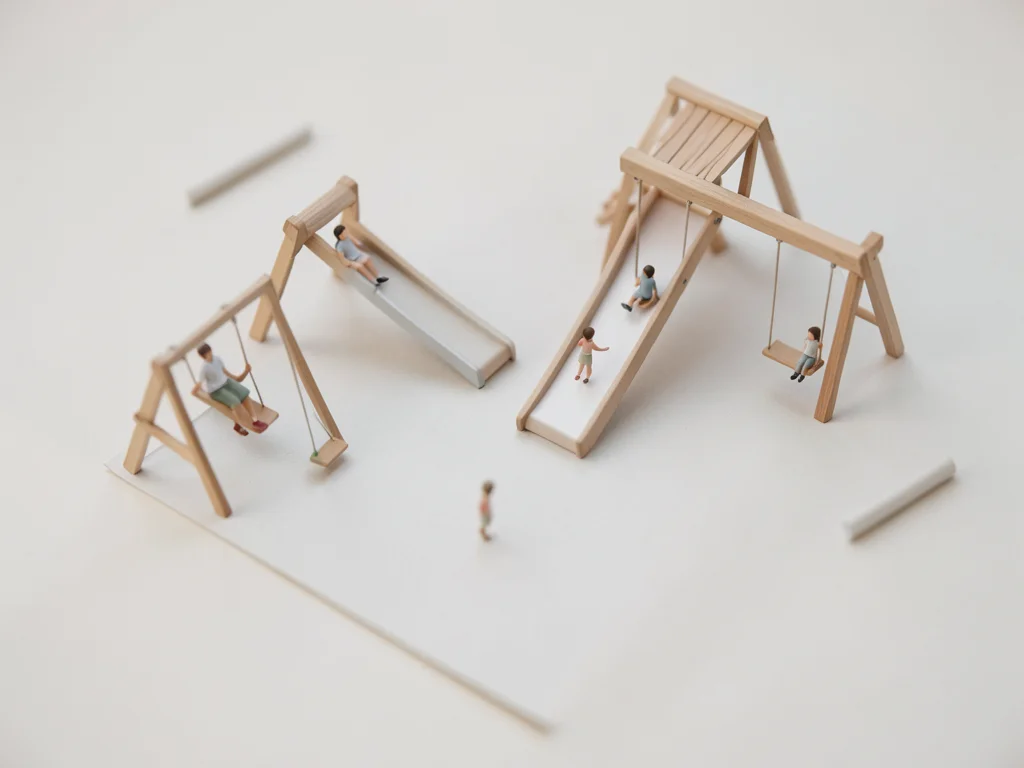 Playground from above, tilt-shift, miniature children on tiny slides and swings