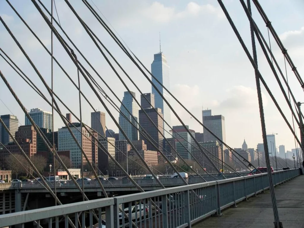 City skyline compressed behind bridge cables