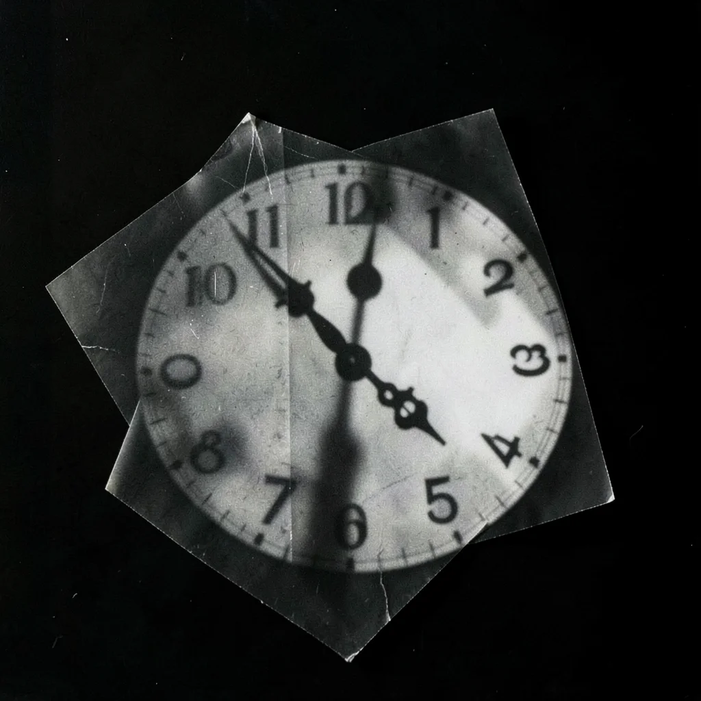 A photogram of a clock face — hands and numerals as shadow silhouette, no visibl