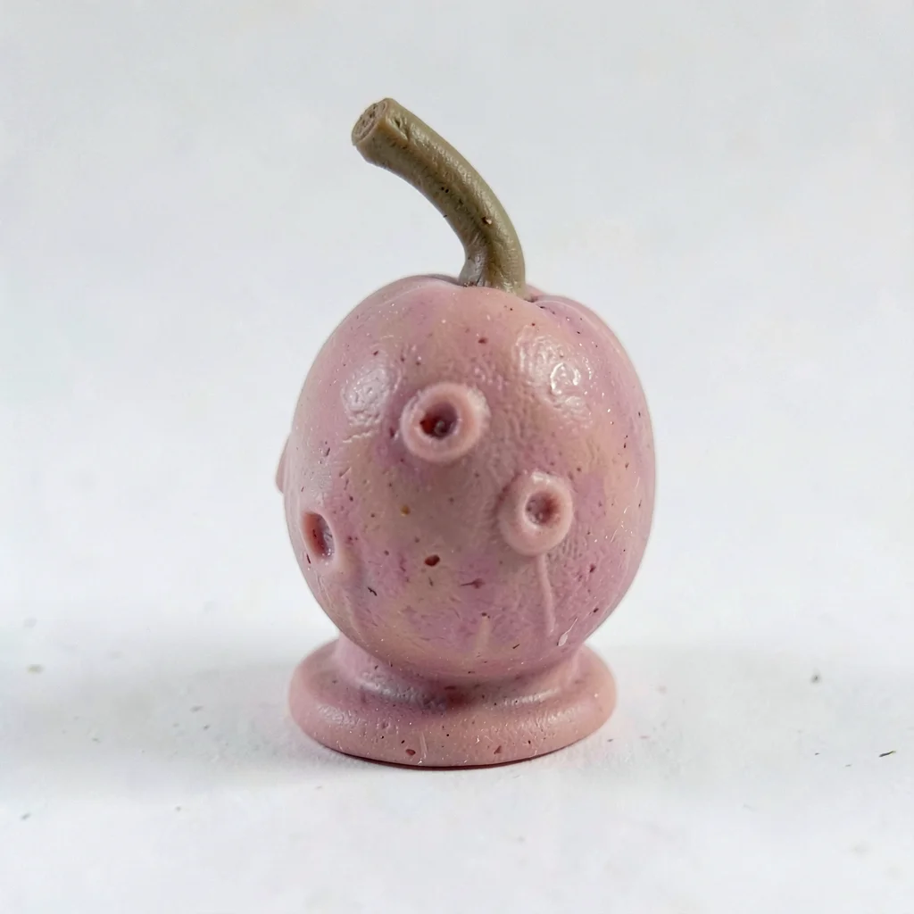 Plucked dusty-rose grape with a slumped stem nub and fingernail dimple on its sk