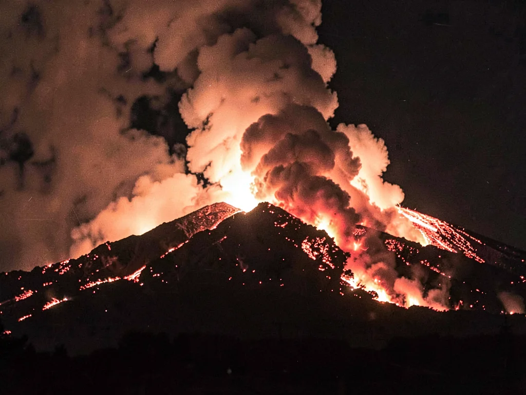 Eruption at night lava illuminating ash