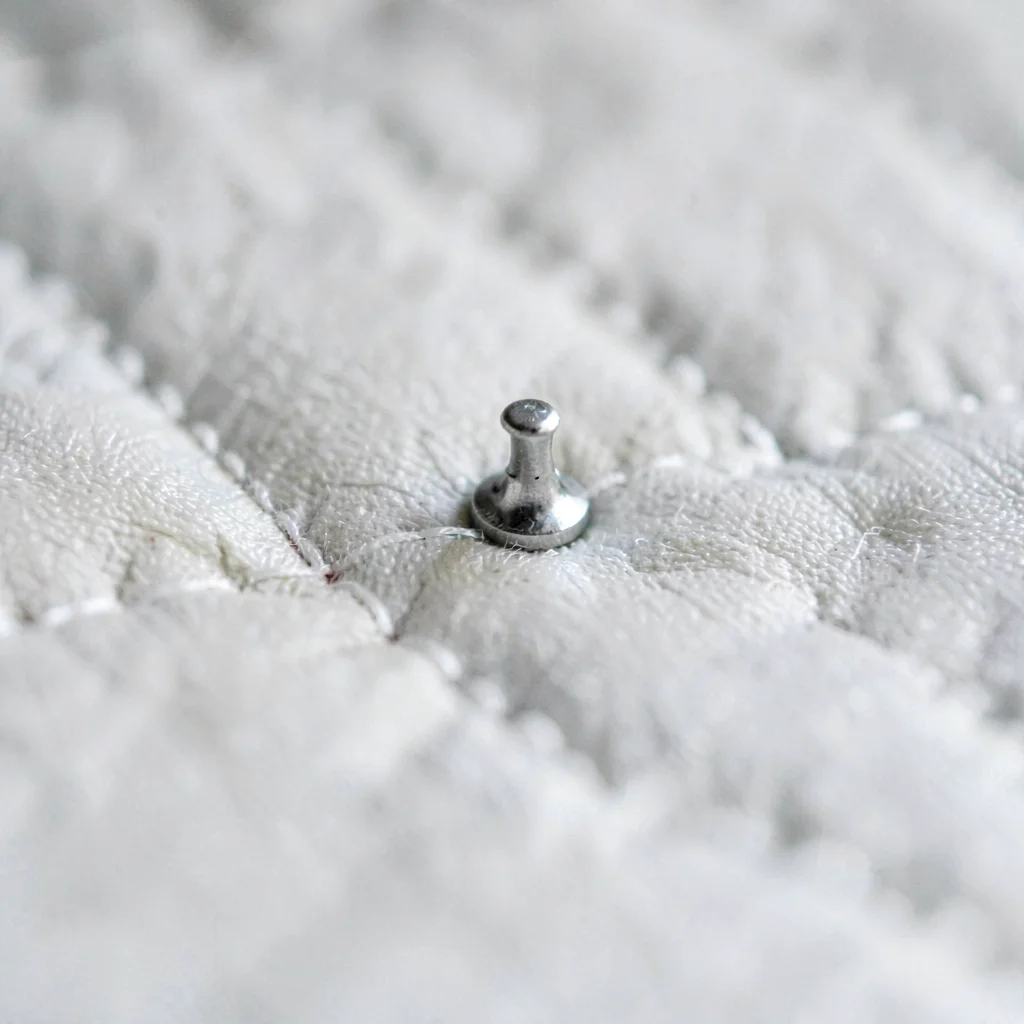 Macro of feed dog impression on freshly machine-quilted line