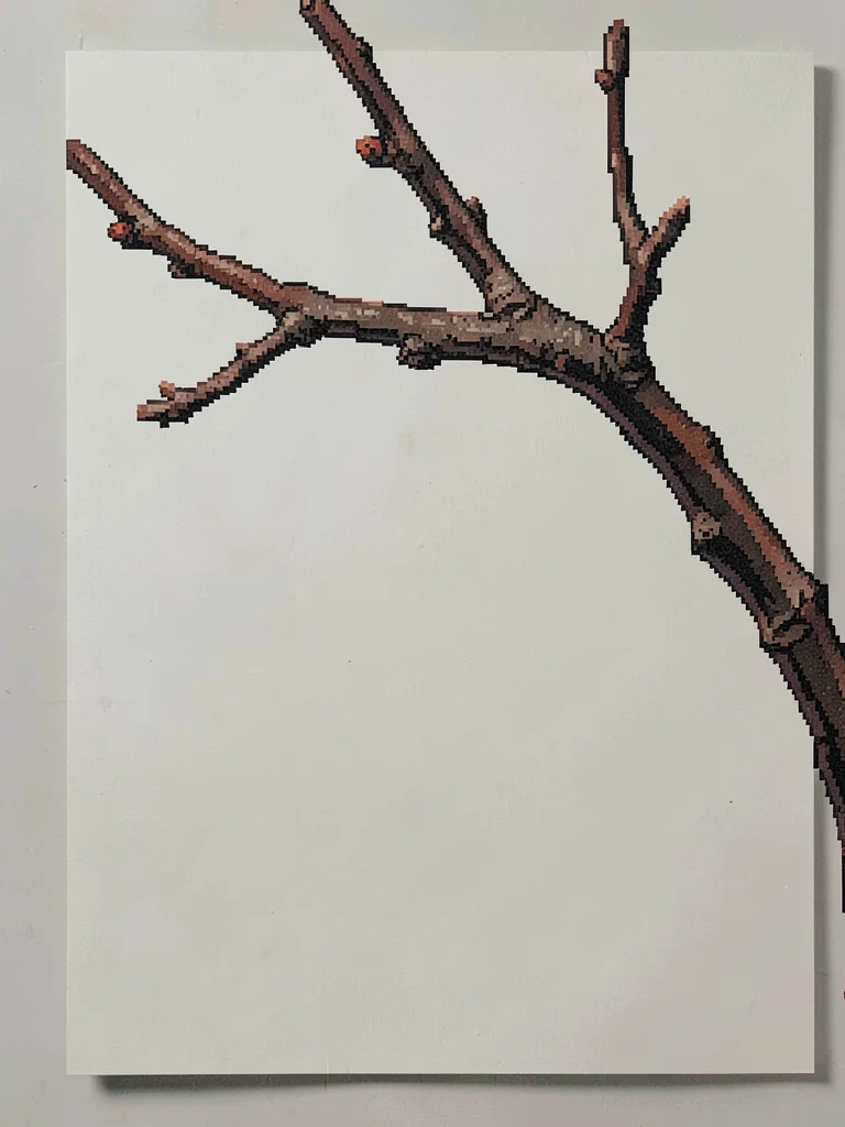 The bare twig of a winter plum branch arched against an empty paper screen lit b