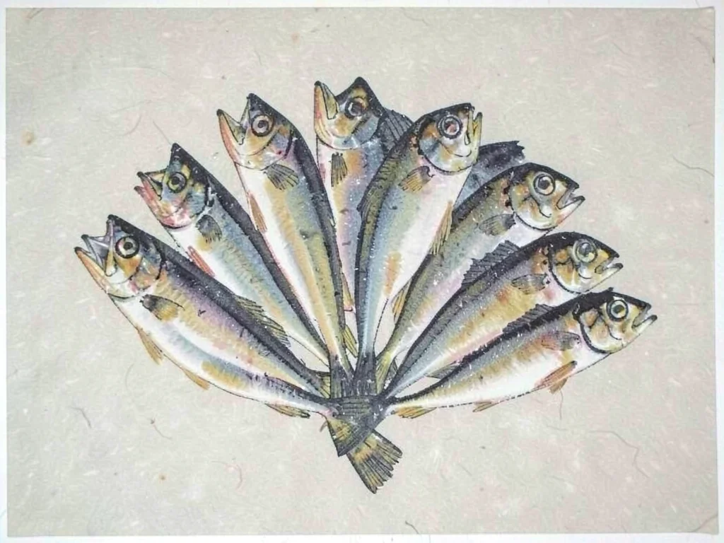 Mackerel fish arranged in a fan pattern on pale washi paper