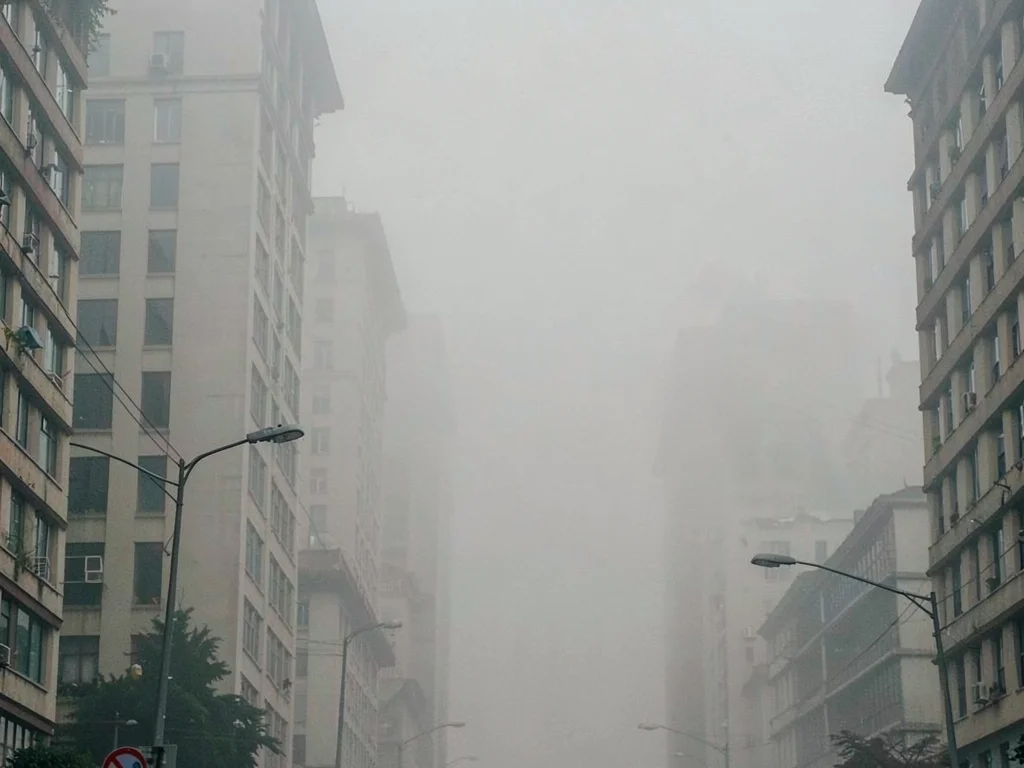Urban canyon in smog filling