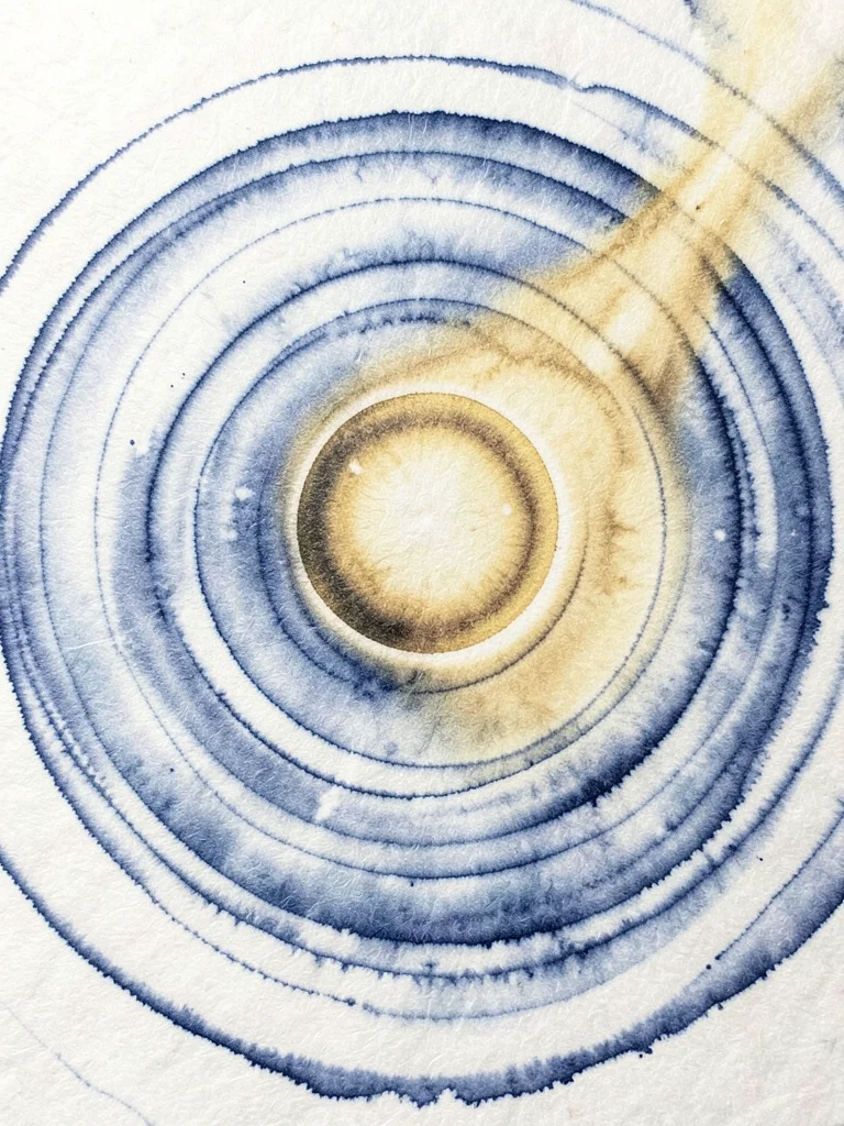 A solar prominence arcing off the edge of a dense golden ink circle representing