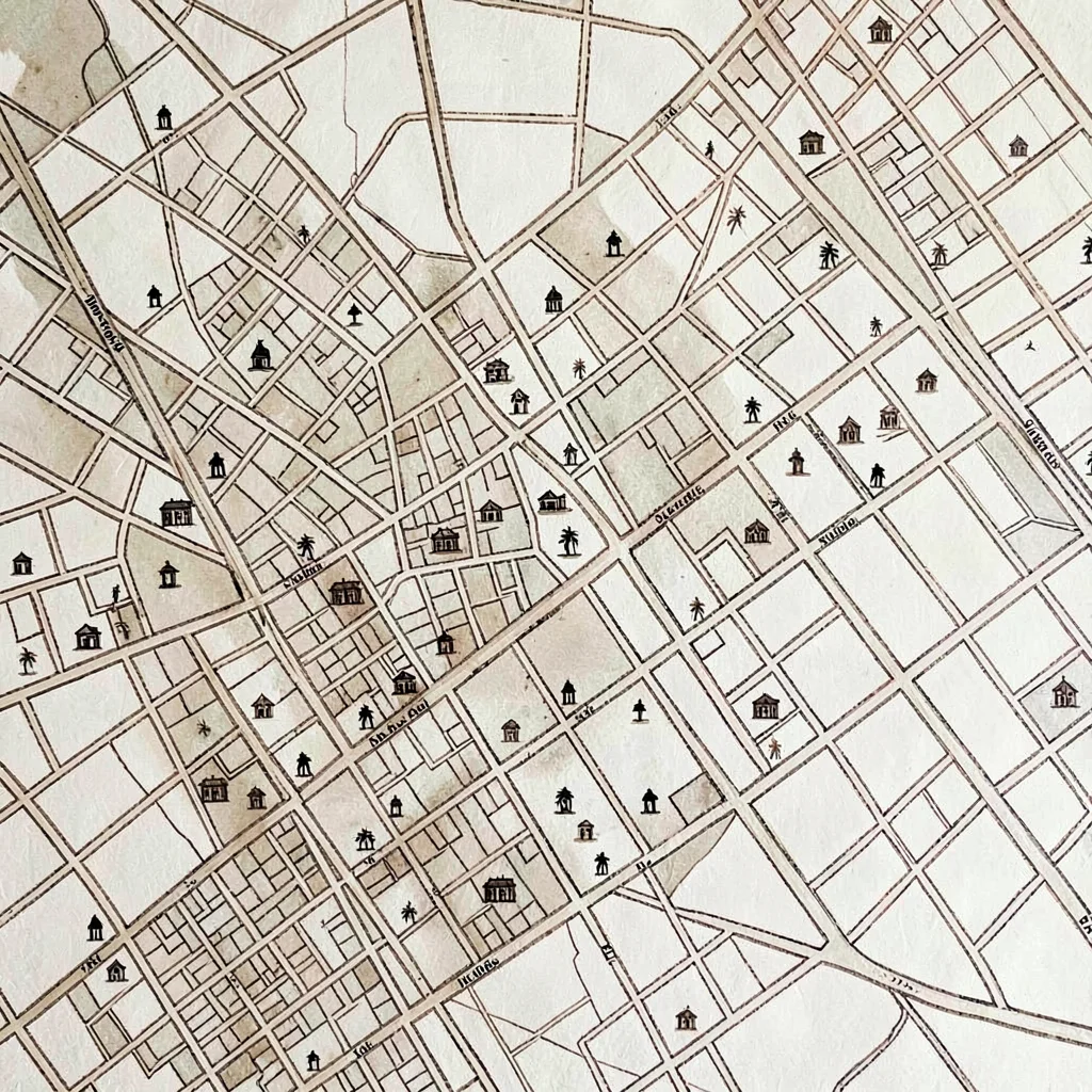 Sepia-ink map of a city neighborhood with tiny landmark icons