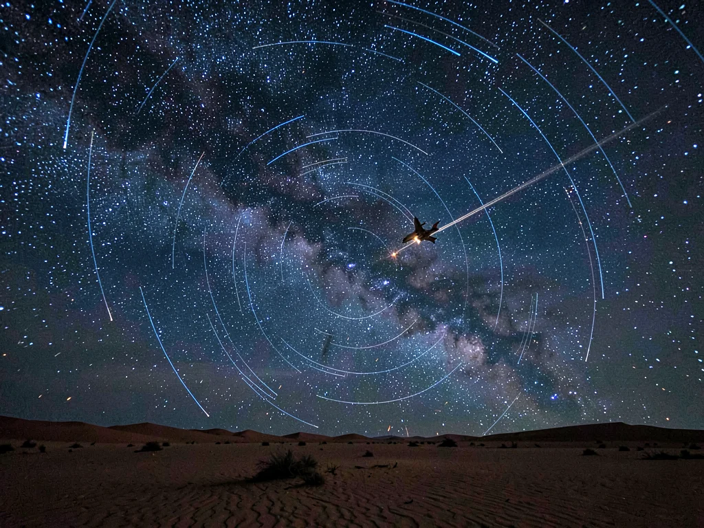 Aircraft crossing star trail field