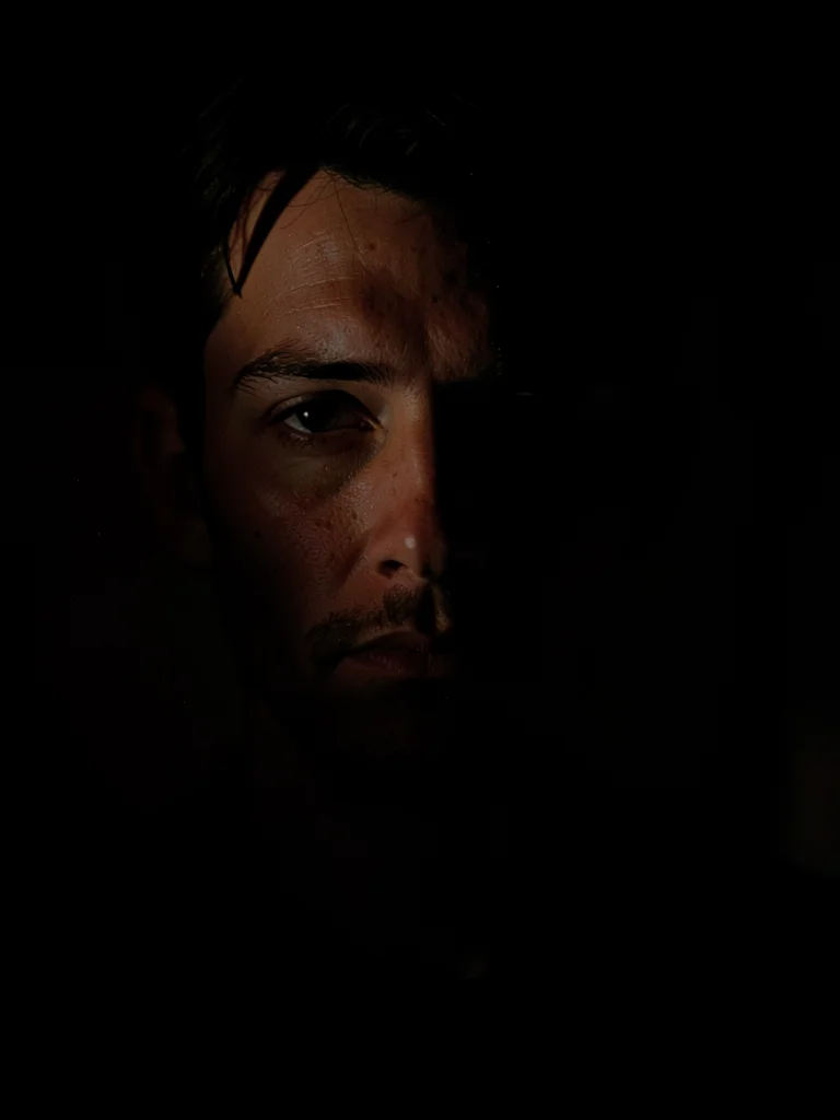 Face lit by phone screen in dark