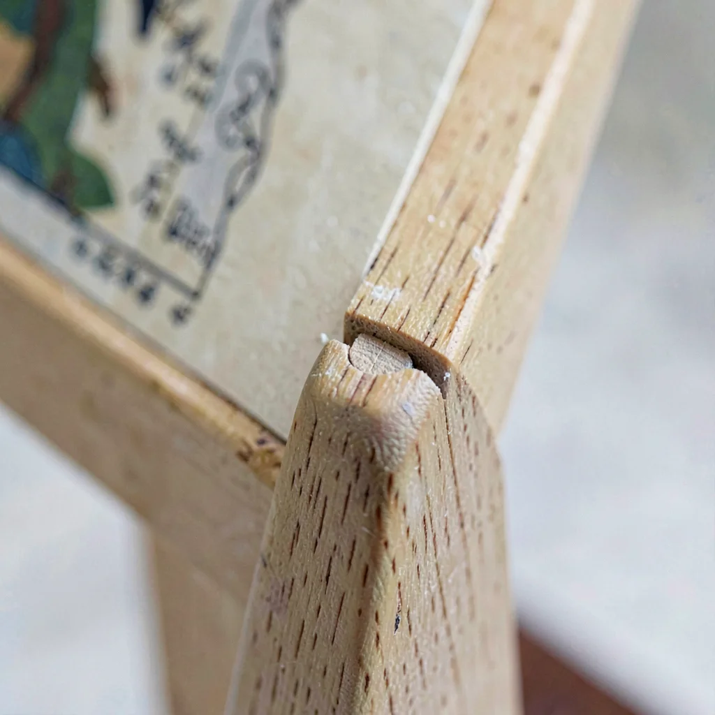 Mineral close-up of a hand-cut mortise joint on an easel leg
