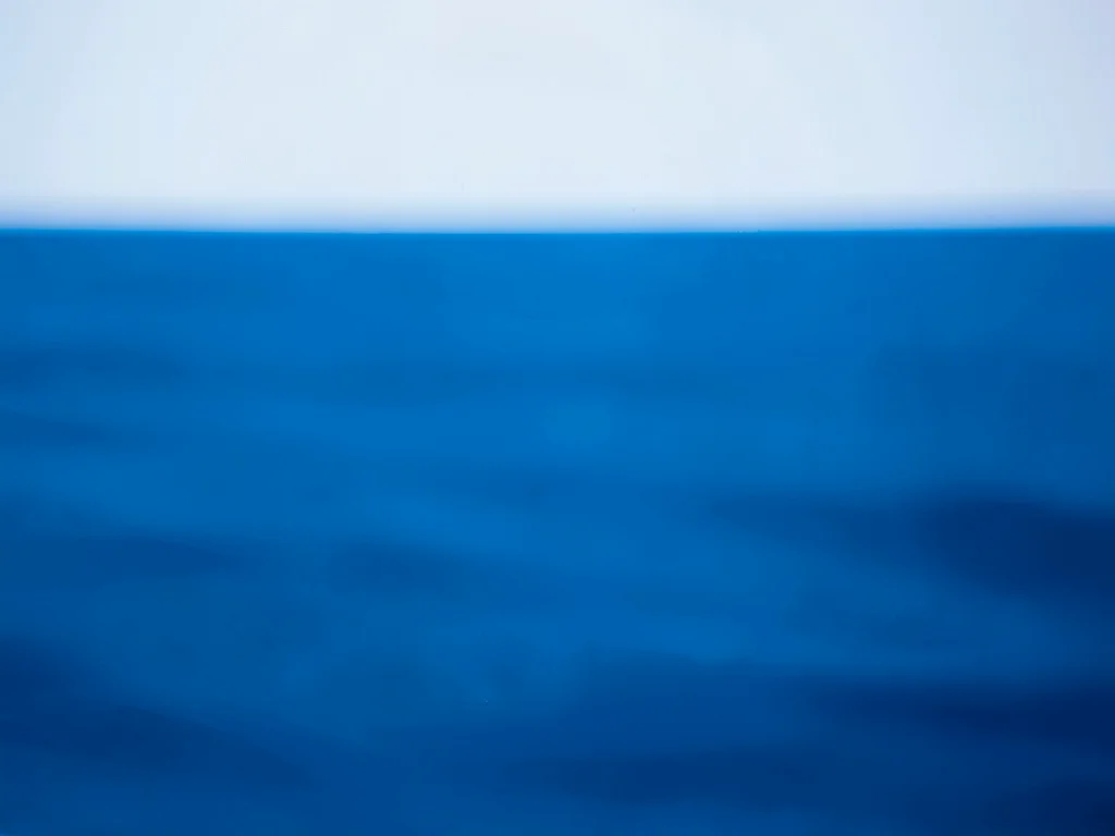 Sea surface blurred to solid blue