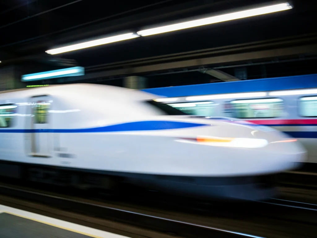 Japanese bullet train passing creating pure horizontal streak of white and blue
