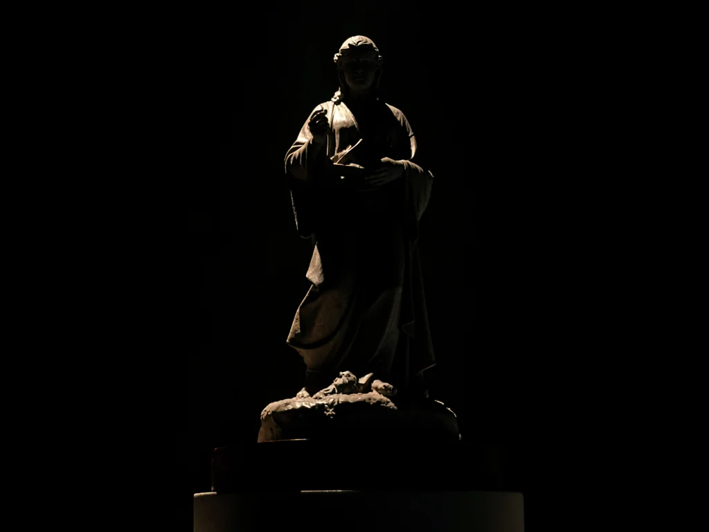 Statue lit from below dramatic
