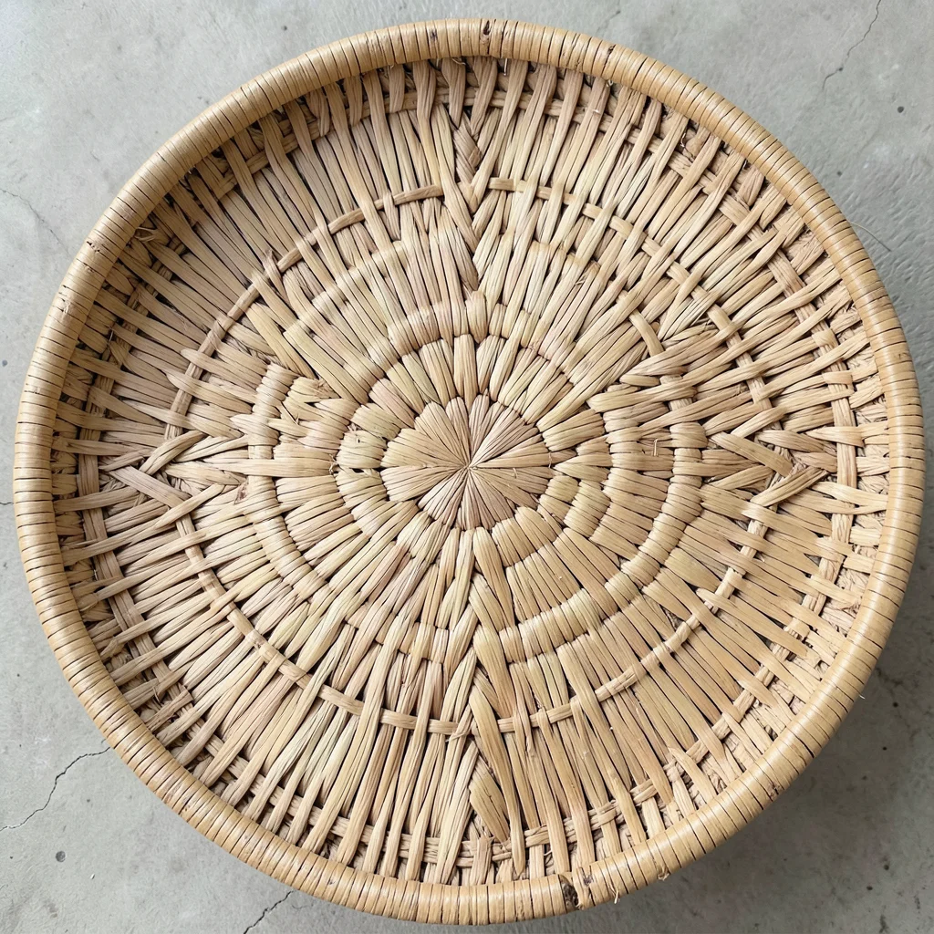 Hand-woven basket texture, palm frond material, geometric pattern, overhead shot