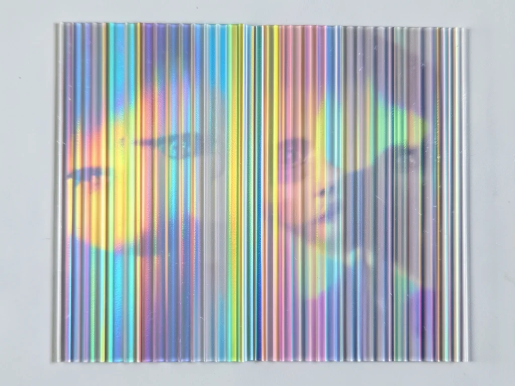 Holographic sticker surface at flat angle, single-color zone of the rainbow refl