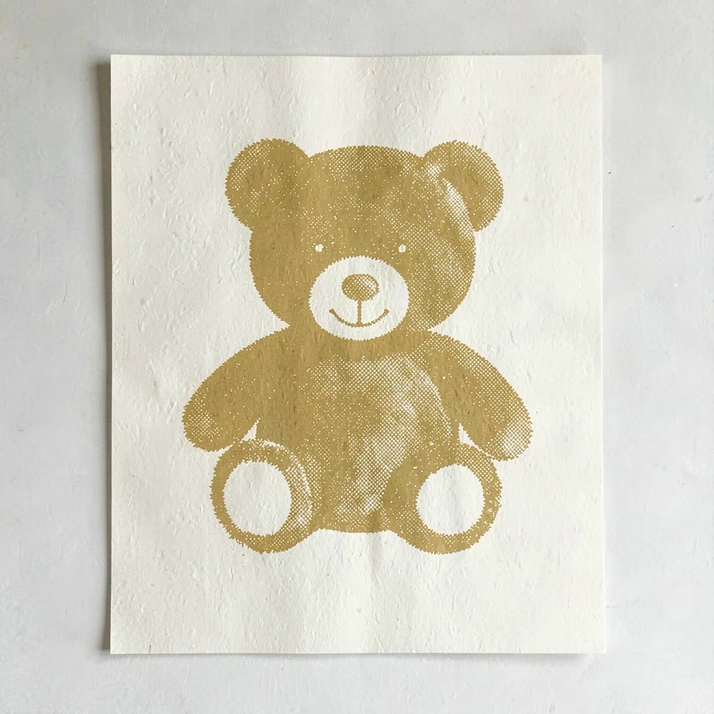 Riso poster motif of a halftone teddy bear silhouette in mustard yellow on warm 