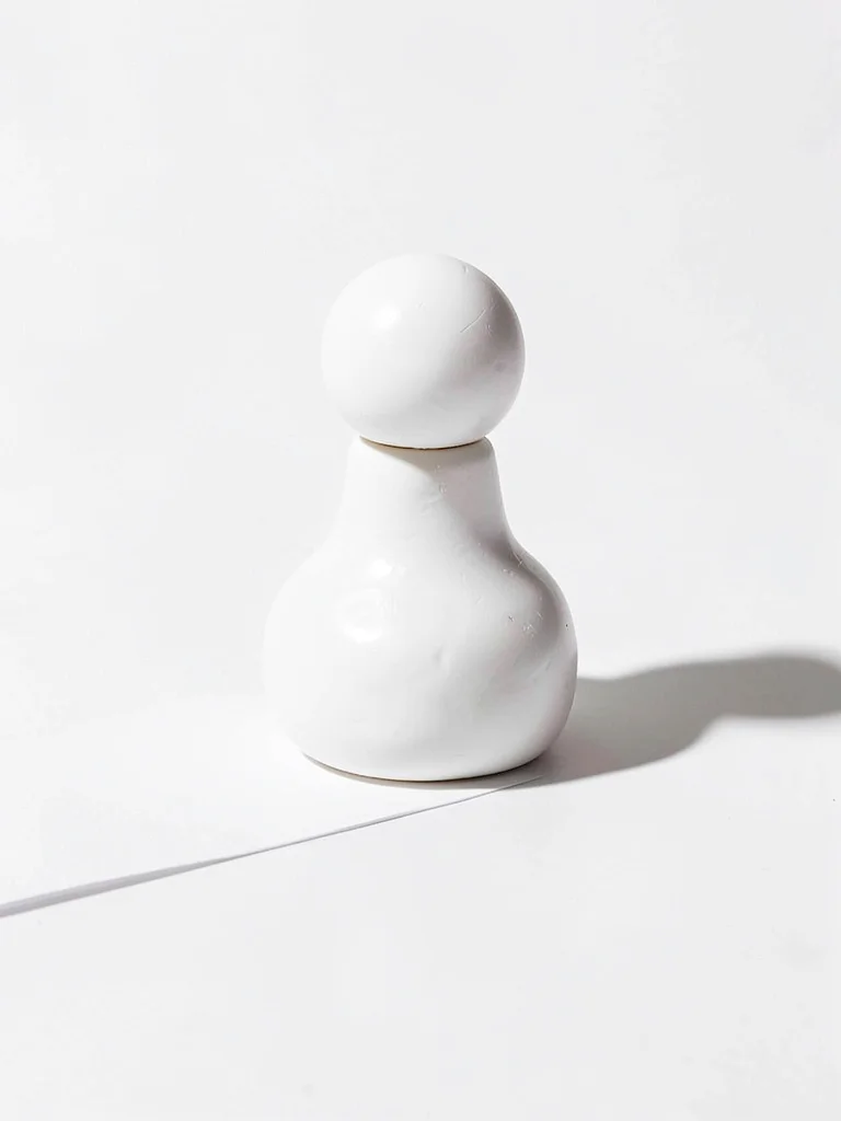 Rotund chunky clay chess piece pawn in primary white with stubby round head and 