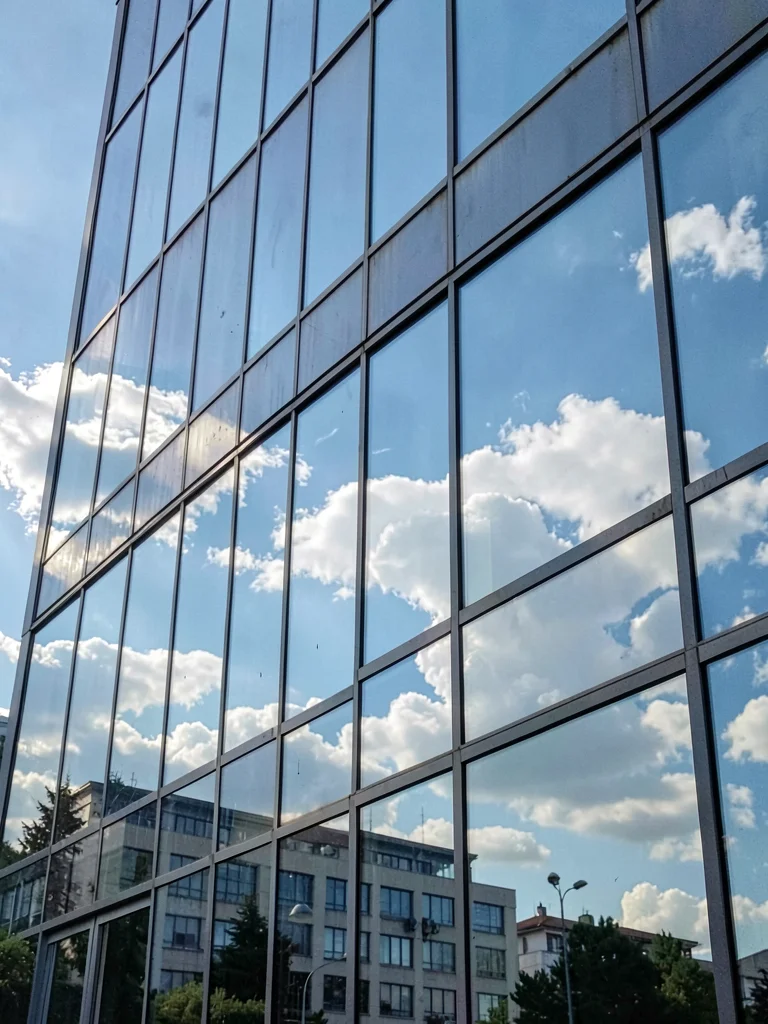 Glass facade reflecting sky