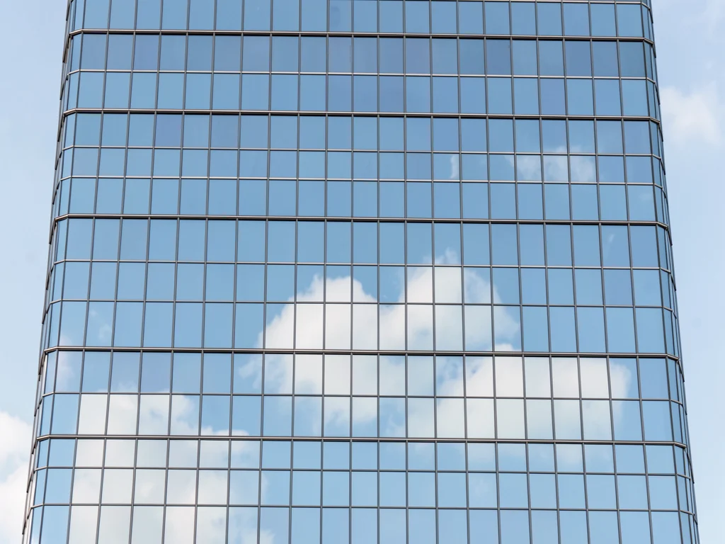 Curtain-wall office tower elevation showing nothing but a perfect grid of mirror
