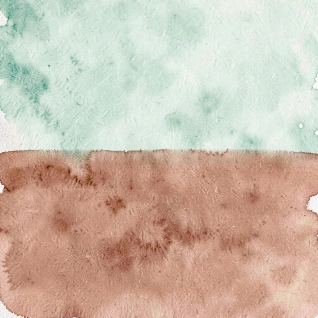 A pure color-field of pale celadon meets a pure field of dusty terracotta along 