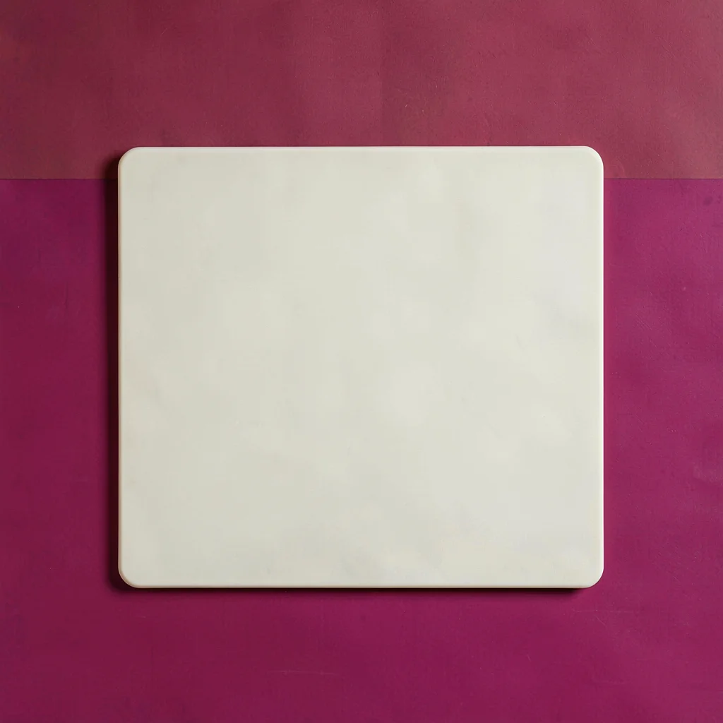 single matte-cream silicone trivet-mat top-down on a saturated raspberry backdro