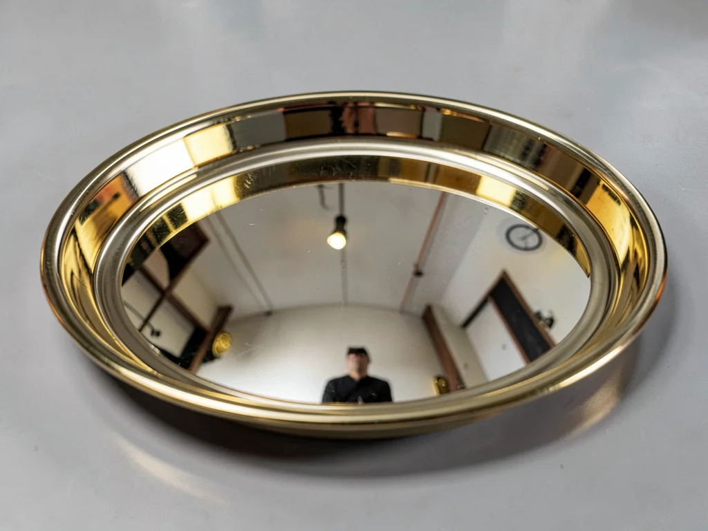Polished brass tray reflecting room distorted