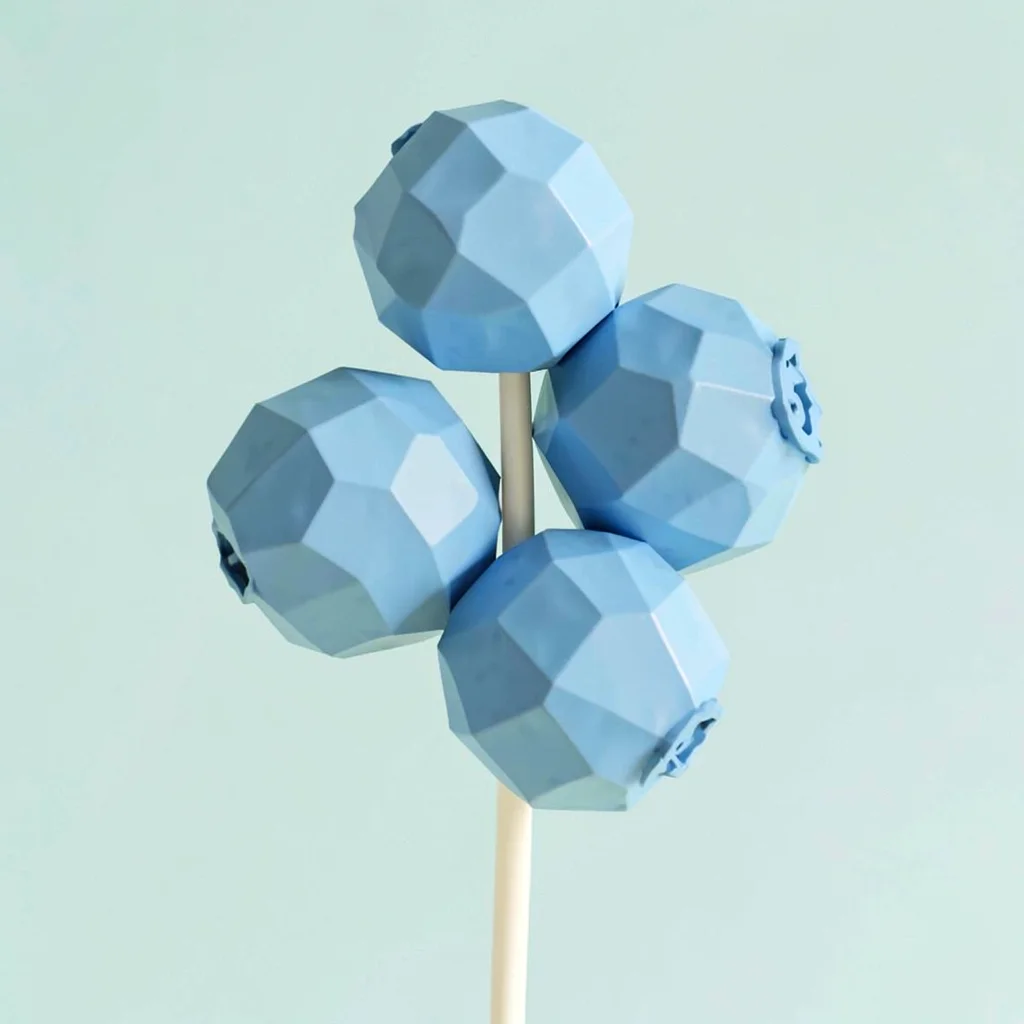 Clustered sky-blue lowpoly blueberries of five chunky orbs on a cream stem, on p