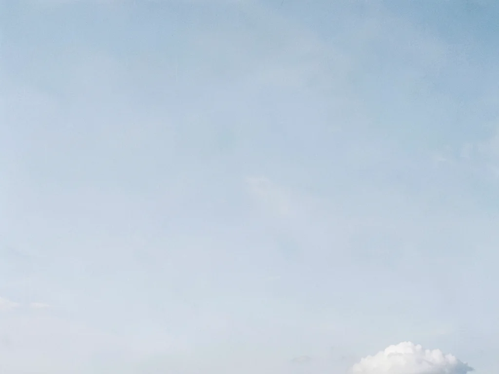 One small cloud in lower corner of enormous pale blue sky