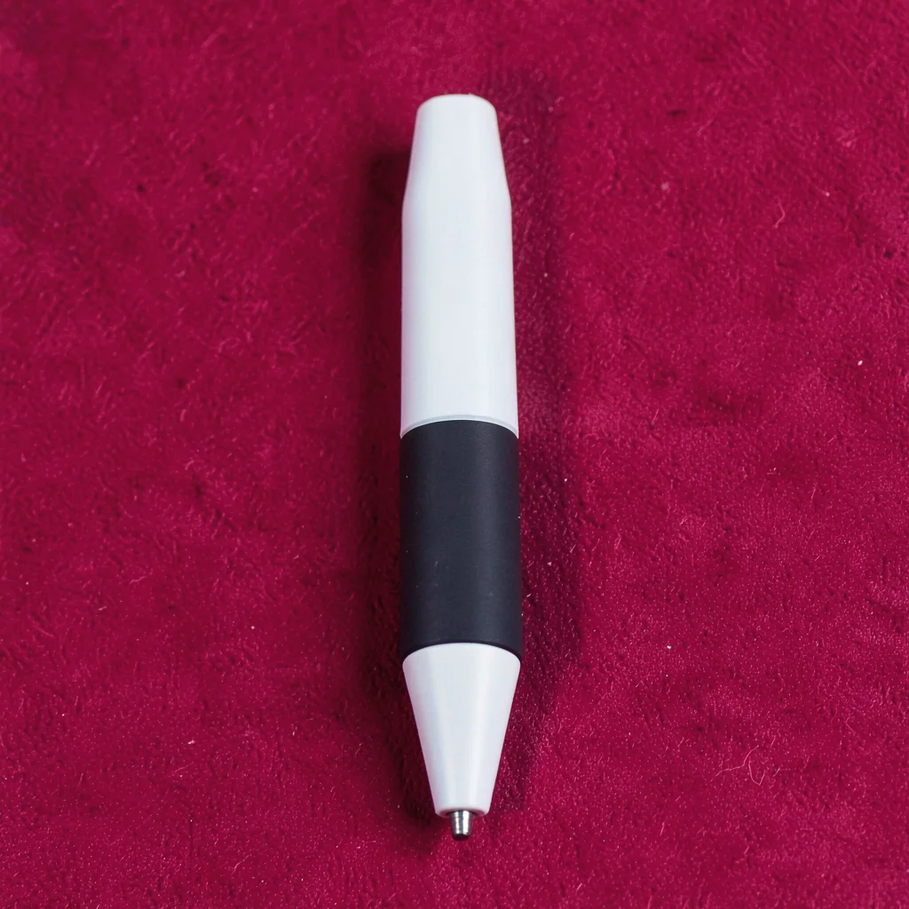 single matte-finish portable ergonomic stylus pen top-down on a saturated raspbe
