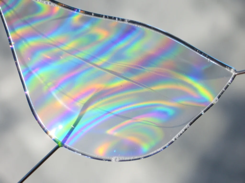 Soap film with intentional airflow, wind distorting the membrane into billowing 