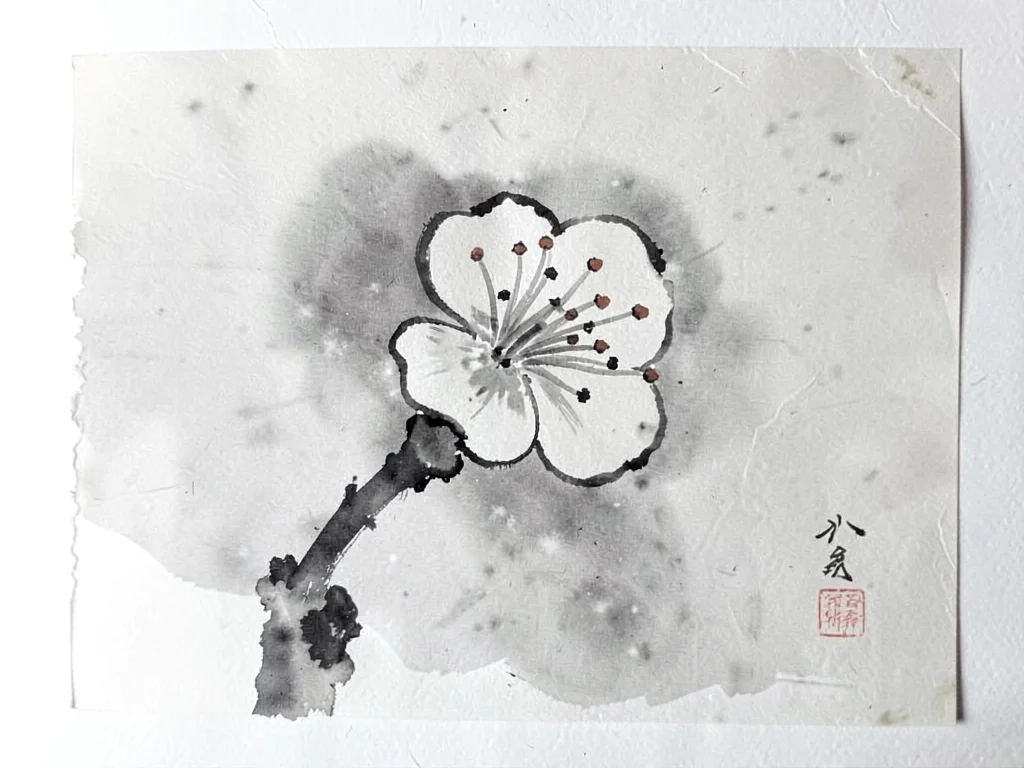 Single plum blossom against soft gray