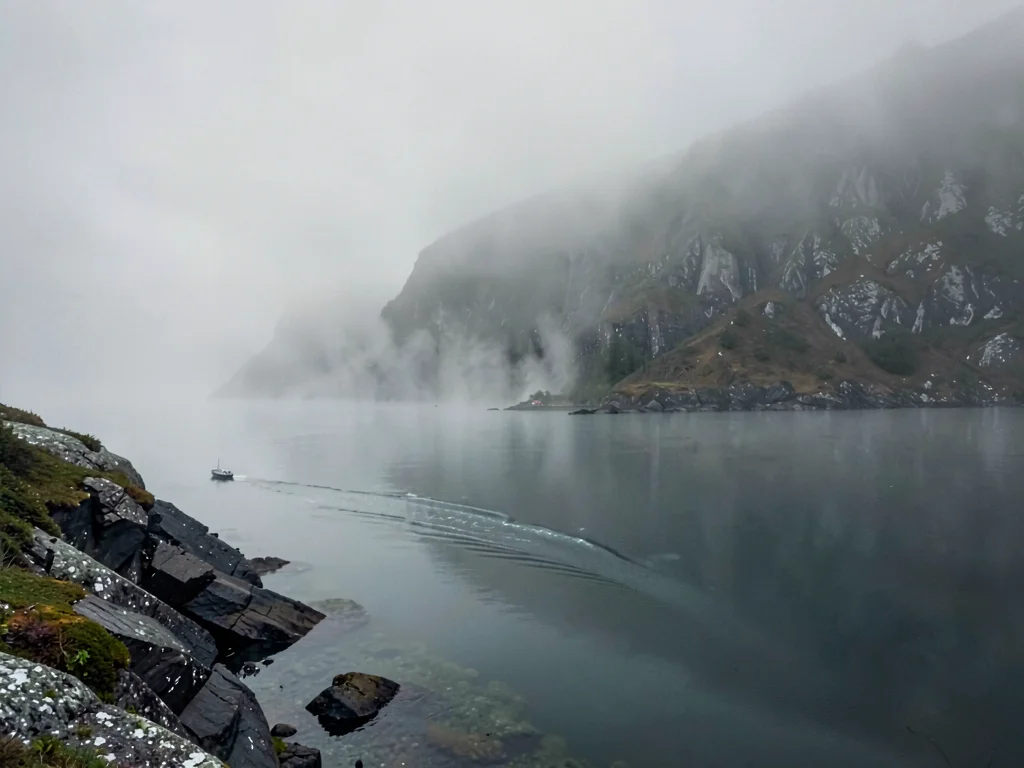 Ferry wake disappearing into mist distance