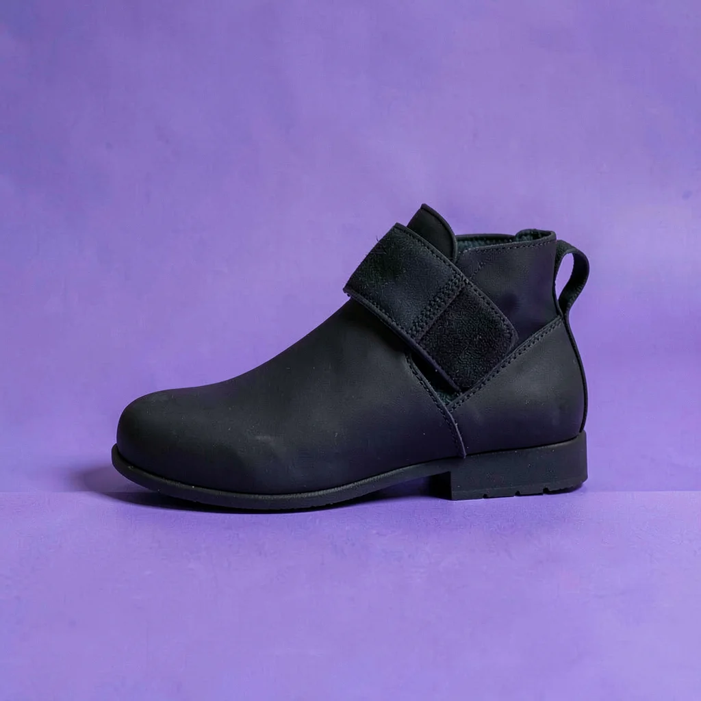 single matte-black ankle-weight strap with a velcro band straight-on against a s