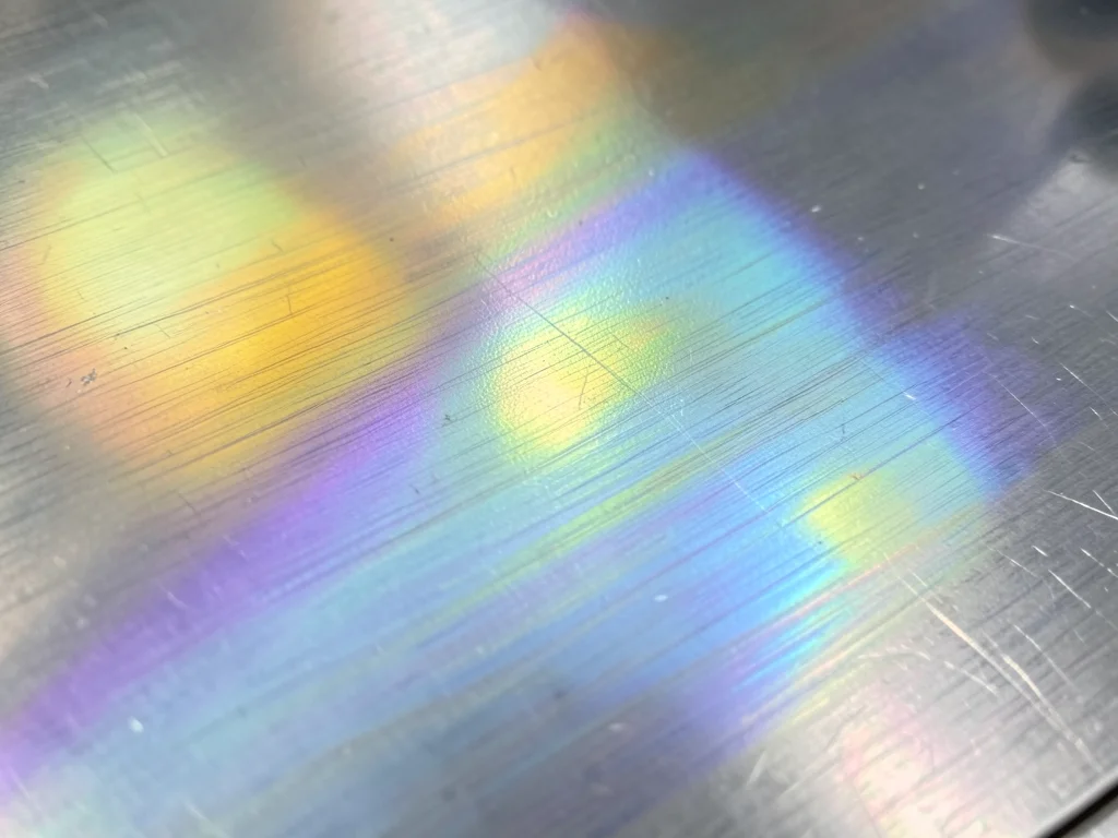 Tempered steel surface showing heat tint colors, oxide film thickness gradient f
