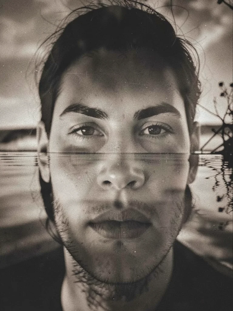 Face reflected in water, solarization applied so reflection and reality swap ton