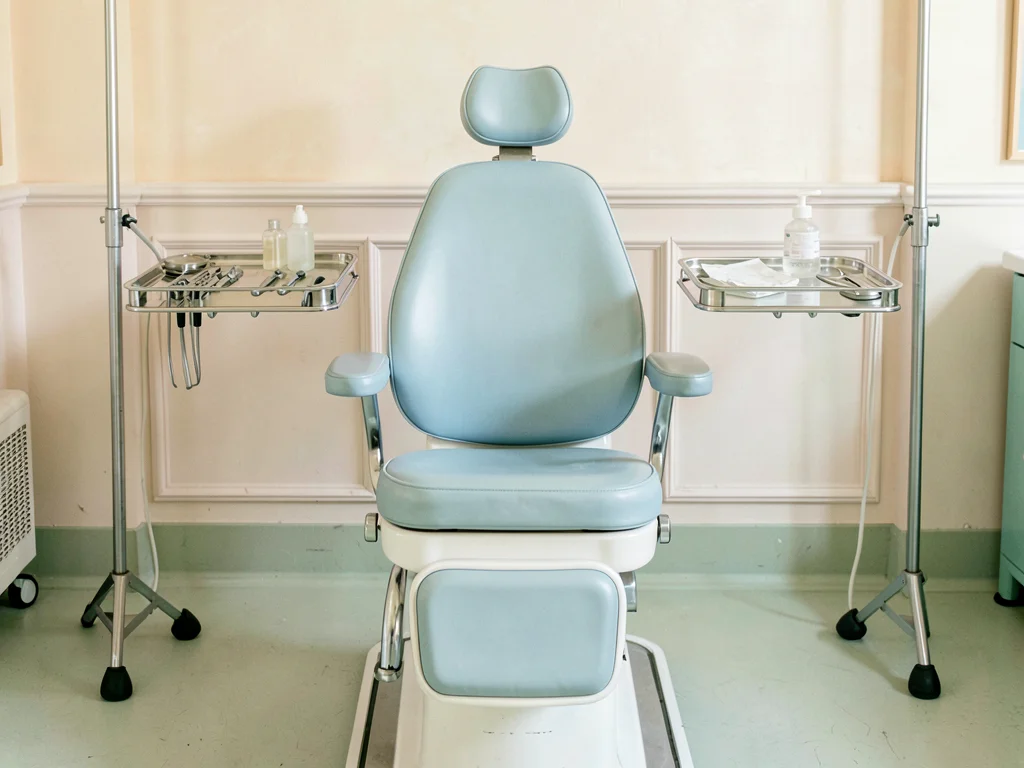Vintage dental chair, powder blue upholstery, chrome accents, symmetrical instru