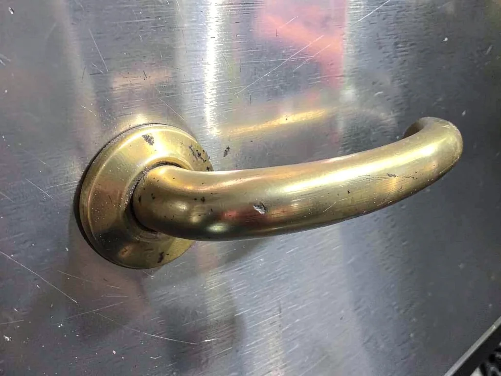 Brass door handle worn smooth