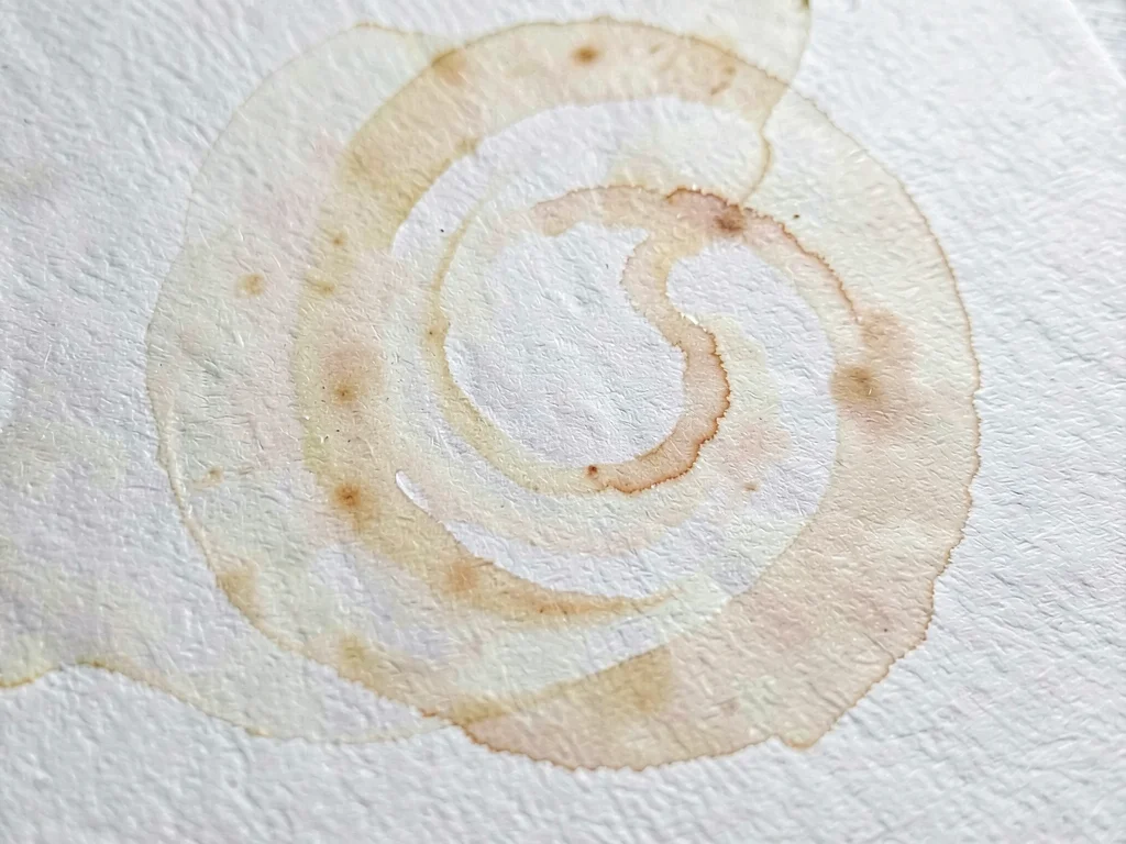 Paste swirl marbling spreading slowly across watercolor cold-press cotton in a p