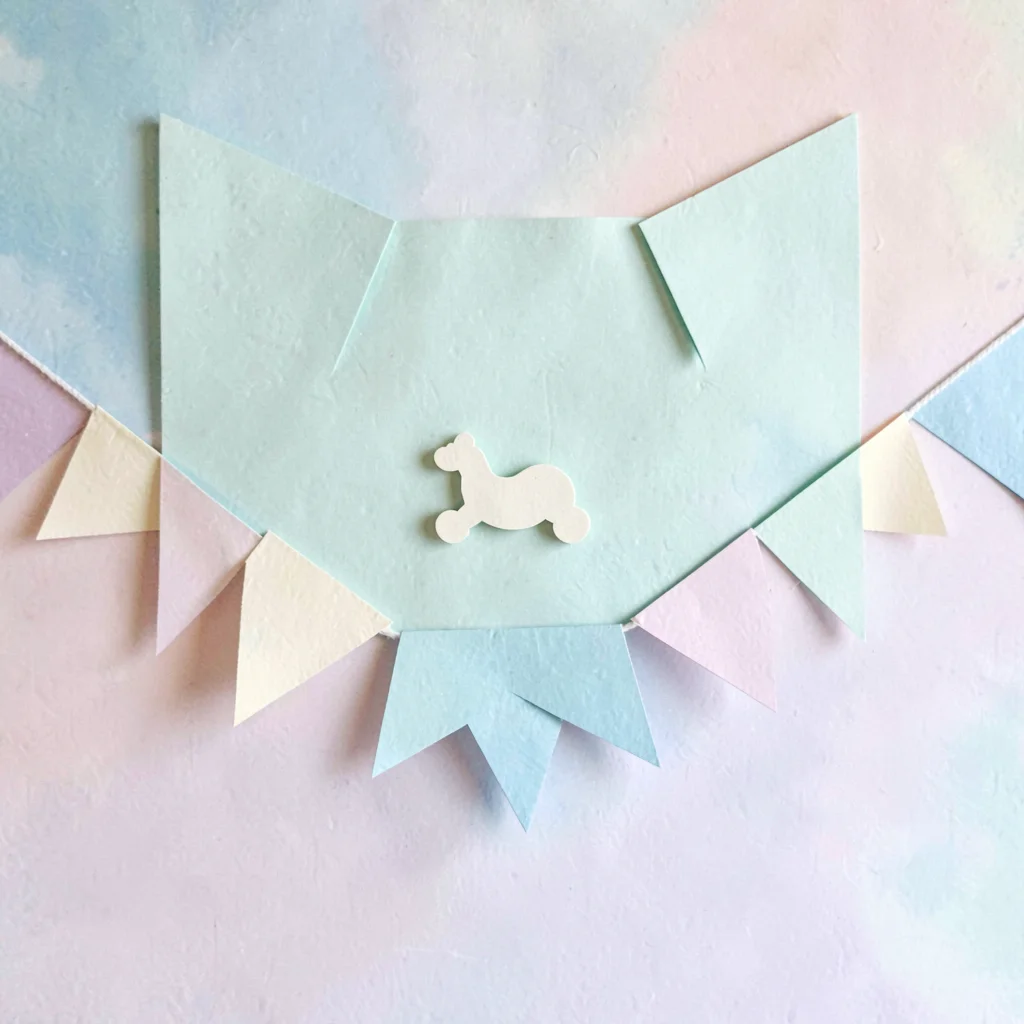 Cut-paper banner of a paper studio backdrop with a tiny rocker silhouette, mint 