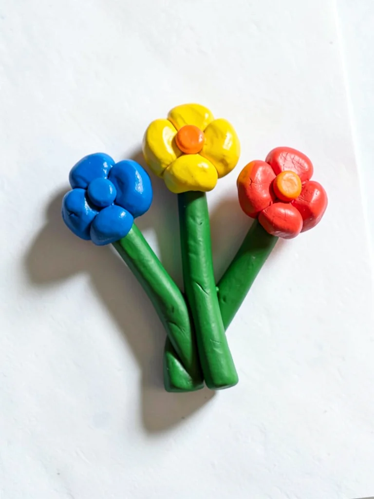 Pretty chunky clay flower bouquet of three primary-color blossoms with stubby gr