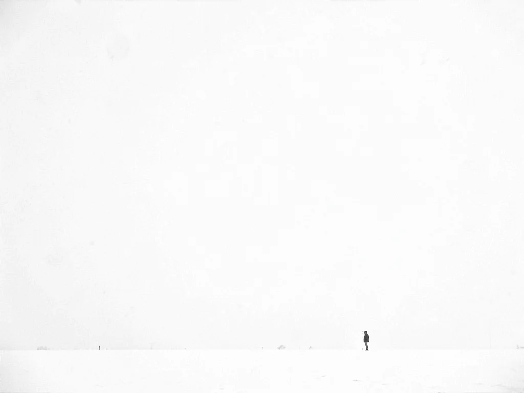 Lone figure tiny in snow vastness