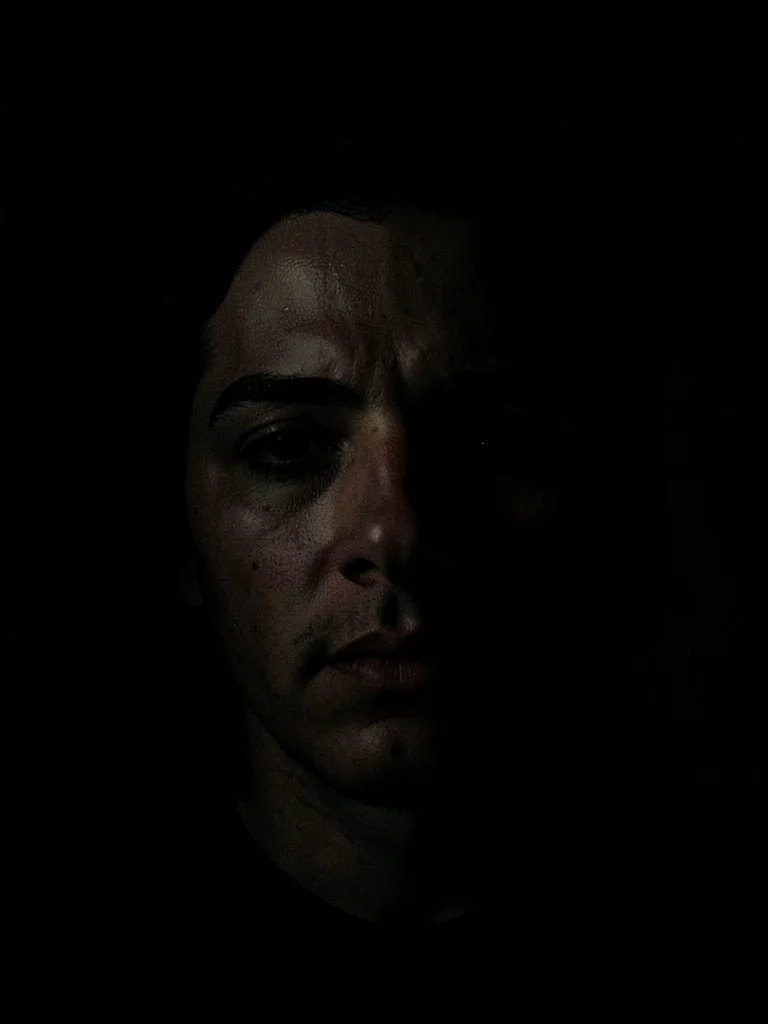 Face lit by phone screen in dark