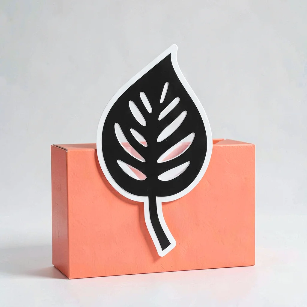 Sticker design study of a stylised fenestrated leaf silhouette on a punchy coral