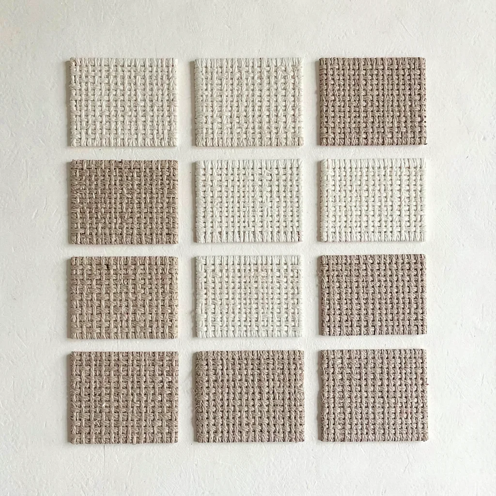 Modular grid of twelve woven texture squares on cream card, faint paper grain