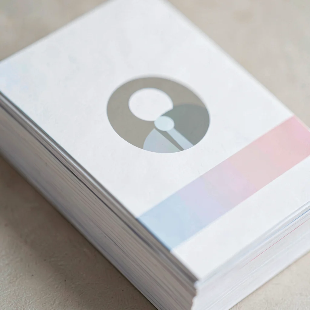 Tight crop of an employee-profile card stack showing a round abstract avatar and